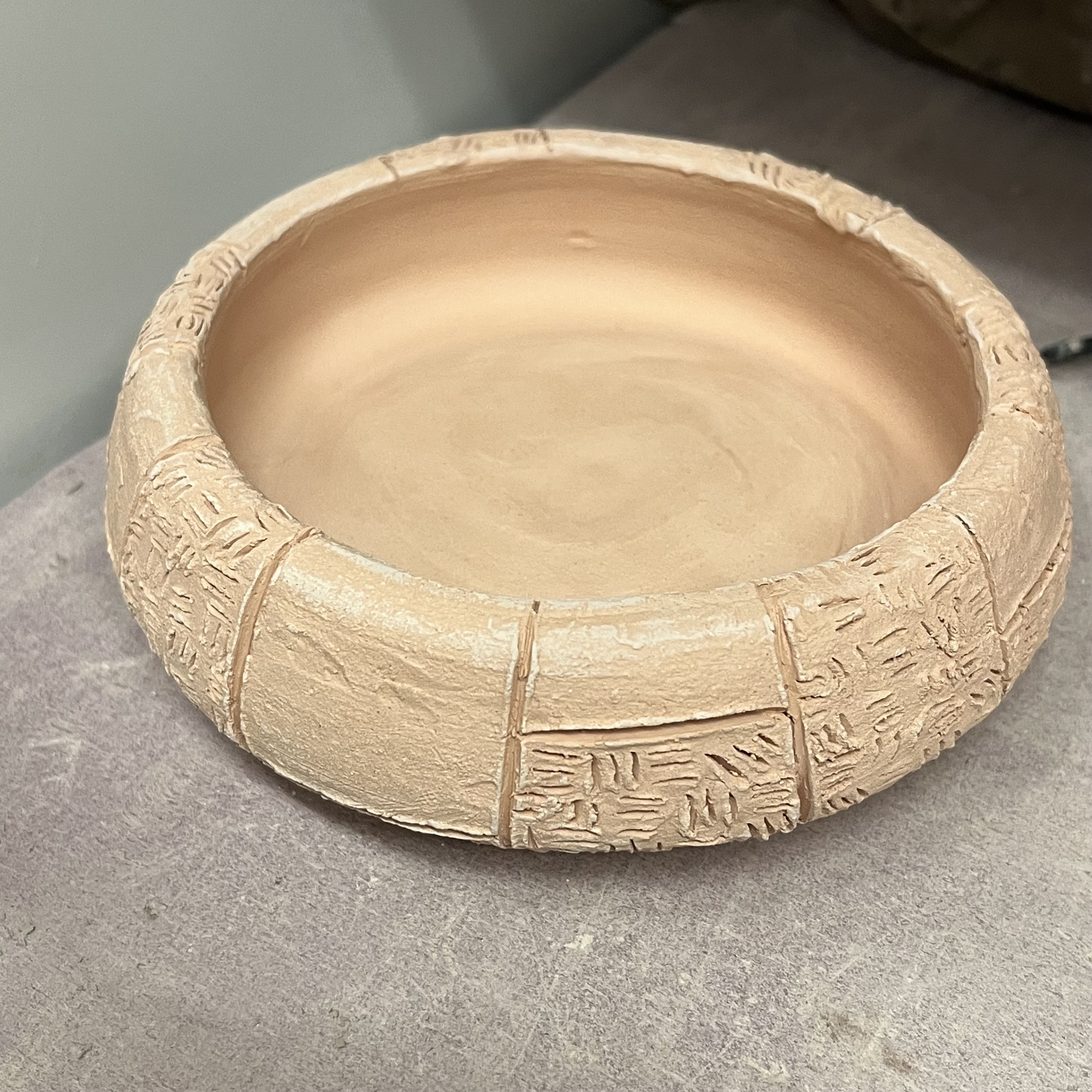 This is what an unglazed Cone 10 bowl looks like after firing; this was made by my friend who is in the glass stream of craft and design but who also does ceramics as his secondary stream. I like how it gets an orange/red sheen to it post firing, which I was told is due to the iron content and how it reacts to the heat in the firing process. It looks a little more orange/yellow in this photo, in real life it is slightly red leaning.